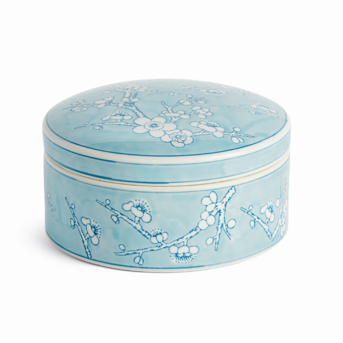 Round bluedecorative box with floral patterns on a white background