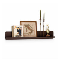 Wooden shelf with decorative items including a magazine, framed map, and trophy on a white background