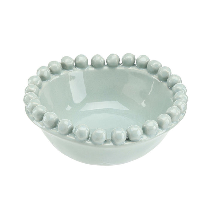 Light blue ceramic bowl with bead-like embellishments on a white background