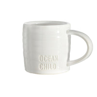 White mug with 'Ocean Child' text on a white background