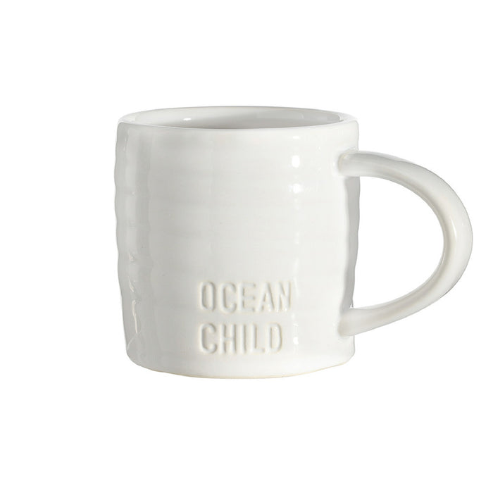 White mug with 'Ocean Child' text on a white background