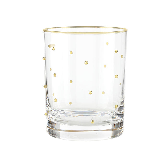 Clear glass tumbler with gold polka dots on a white background