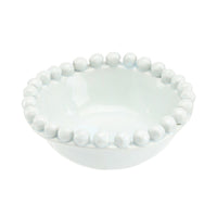 White ceramic bowl with bead-like embellishments on a white background