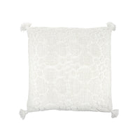 White textured pillow with tassels on a white background