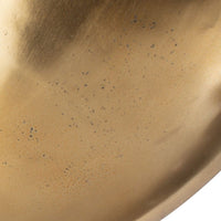 Close-up of a gold-colored metal surface with specks