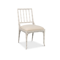Sarreid, Ltd. Elora Working White Dining Chair (set of 2) features a faux-bamboo frame and cushioned seat.