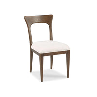 Millback Dining Chair by Woodbridge Furniture features a light cushion, curved backrest, and tapered legs for modern style.
