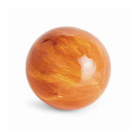 A polished orange stone sphere with natural marbled swirls of amber and yellow, shown on a clean white background.