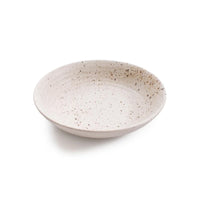 A shallow round ceramic plate with a speckled beige and brown glaze, photographed on a clean white background.