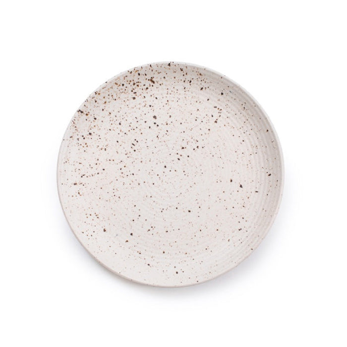 A round ceramic plate with a speckled beige and brown glaze, photographed from directly above on a clean white background.