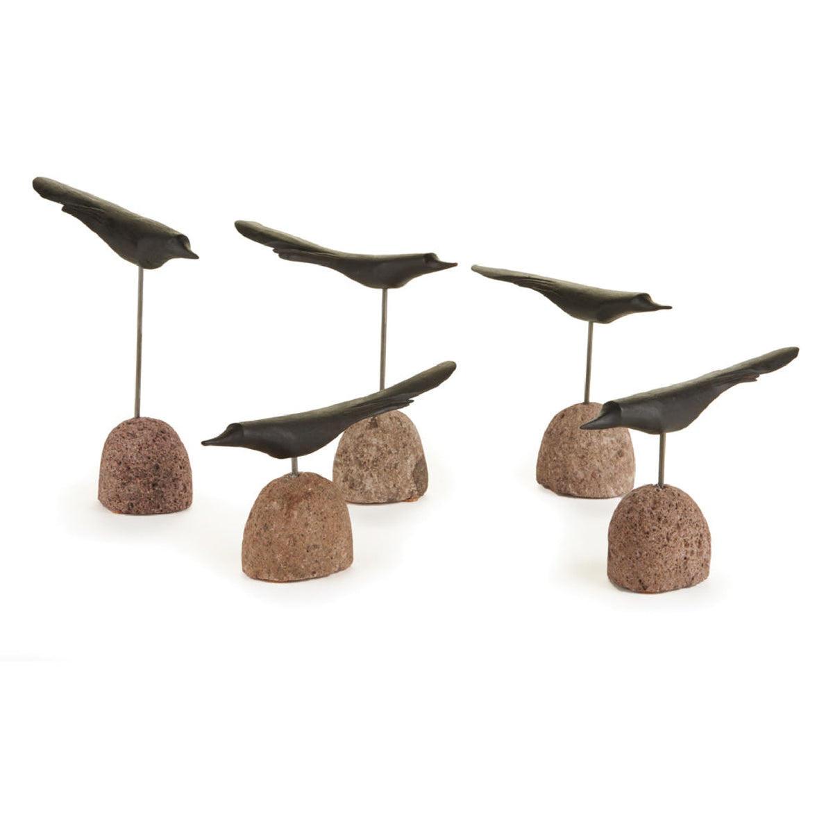 Five bird sculptures made of dark metal mounted on small round stone bases, arranged on a plain white studio background.
