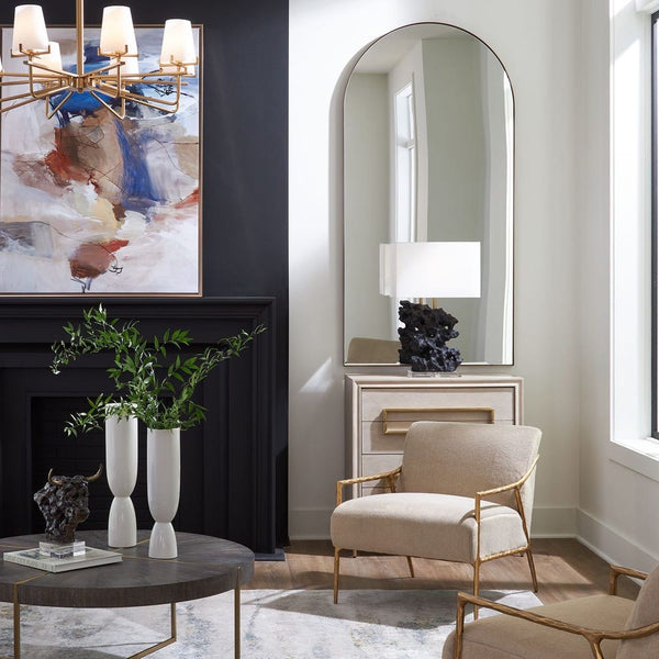 Modern living room with a fireplace, abstract painting, and decorative items.