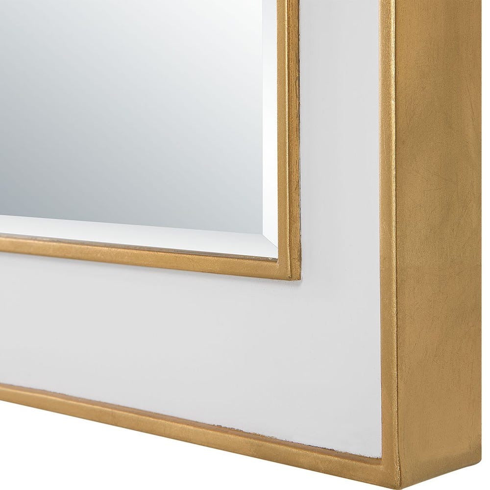 Close-up of a gold-framed mirror on a white background