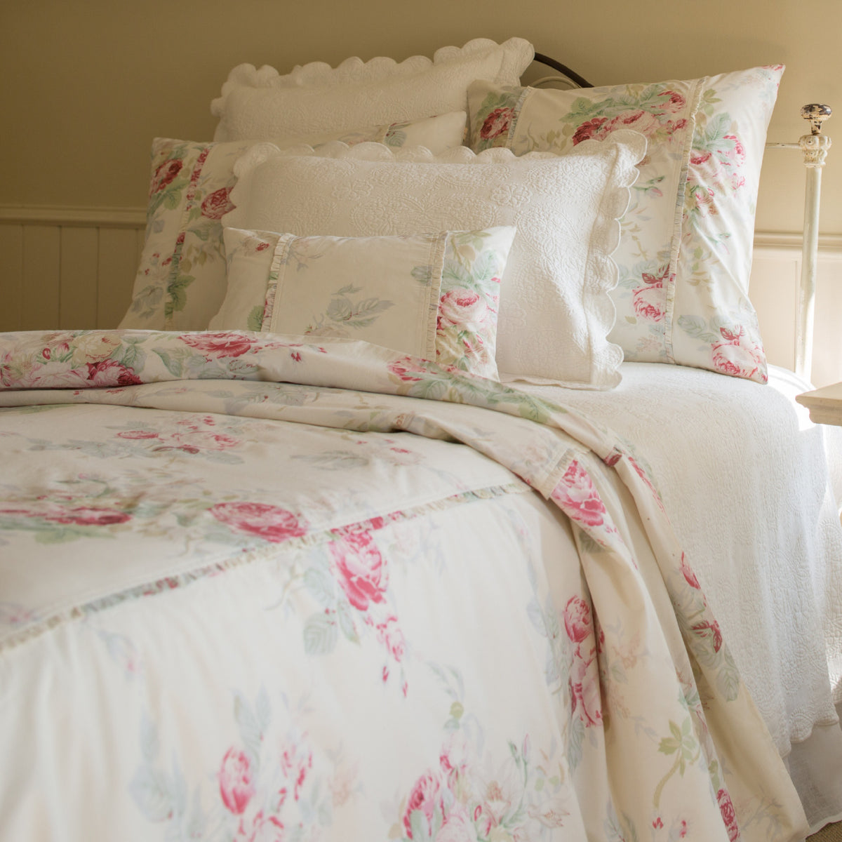 Shore Rose Cream Bedding Collection by Taylor Linens features white floral bedding with pink and green cabbage roses.