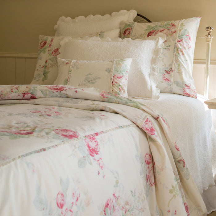 Shore Rose Cream Bedding Collection by Taylor Linens features white floral bedding with pink and green cabbage roses.