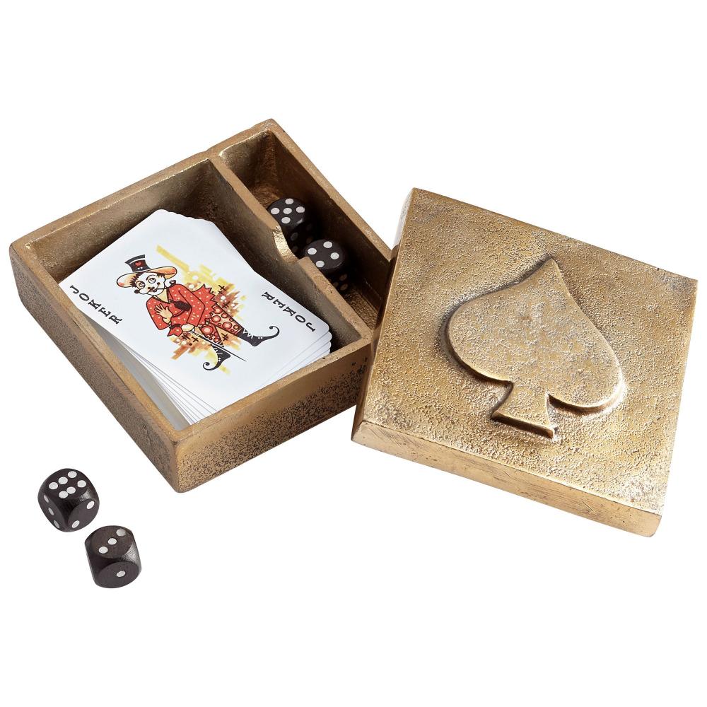 Open brass box with playing cards and dice on a white background