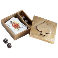 Open brass box with playing cards and dice on a white background