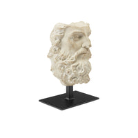 Statue head on a black stand against a white background