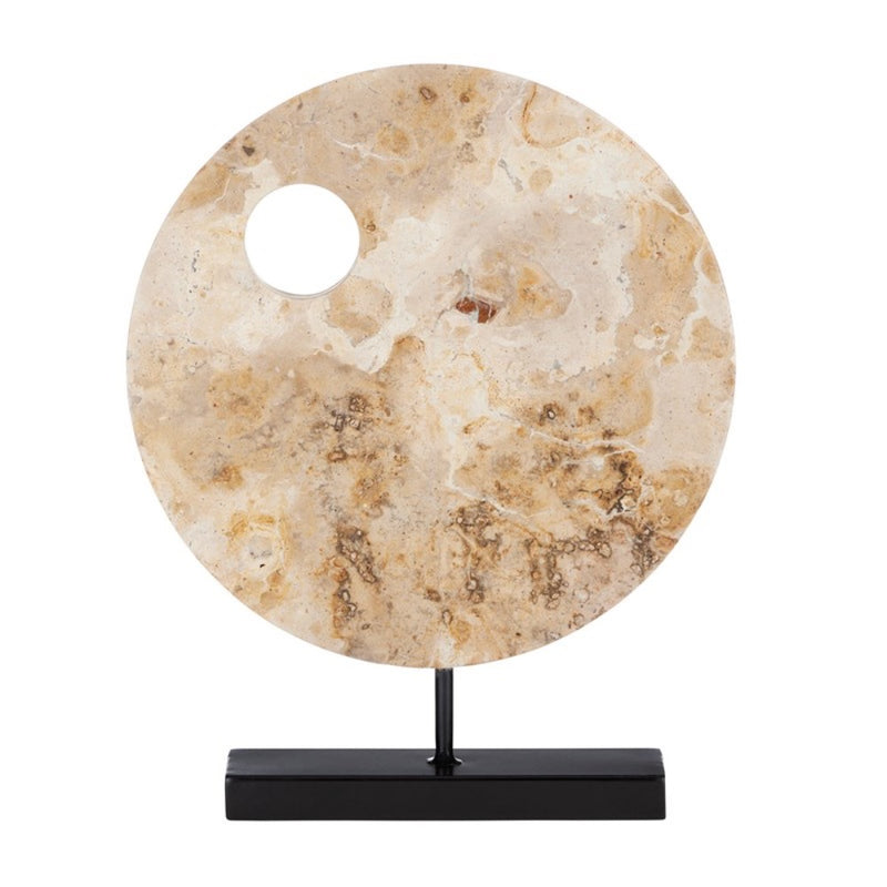 round tan marble sculpture black base