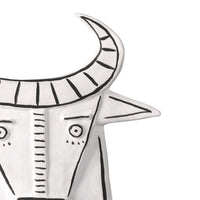 white porcelain cow sculpture open-backed black details