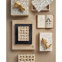 Collection of decorative boxes with artistic designs on a beige surface