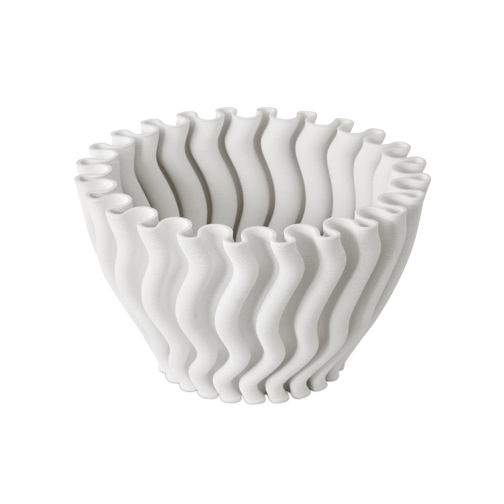 White ceramic bowl with wavy design on a white background