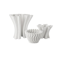 Set of white textured vases and bowls on a white background