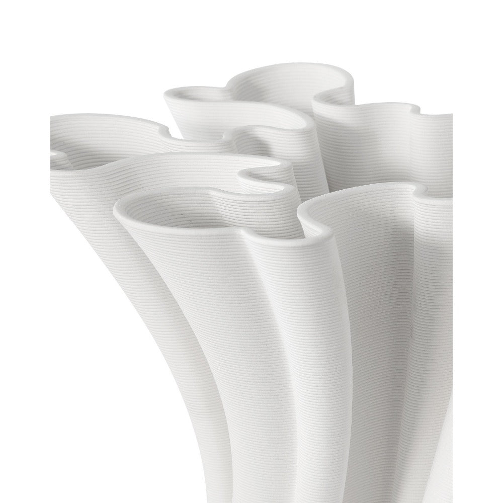 White ceramic vase with wavy design on a white background