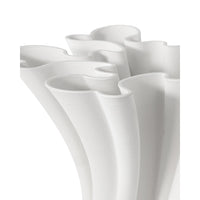 White ceramic vase with wavy design on a white background