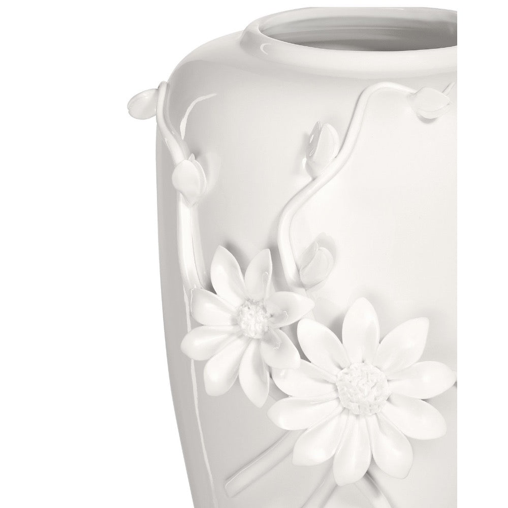 White ceramic vase with floral designs on a white background