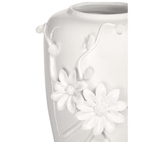 White ceramic vase with floral designs on a white background