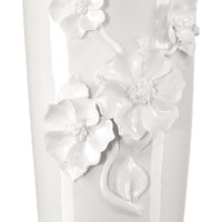 White ceramic vase with floral designs on a white background