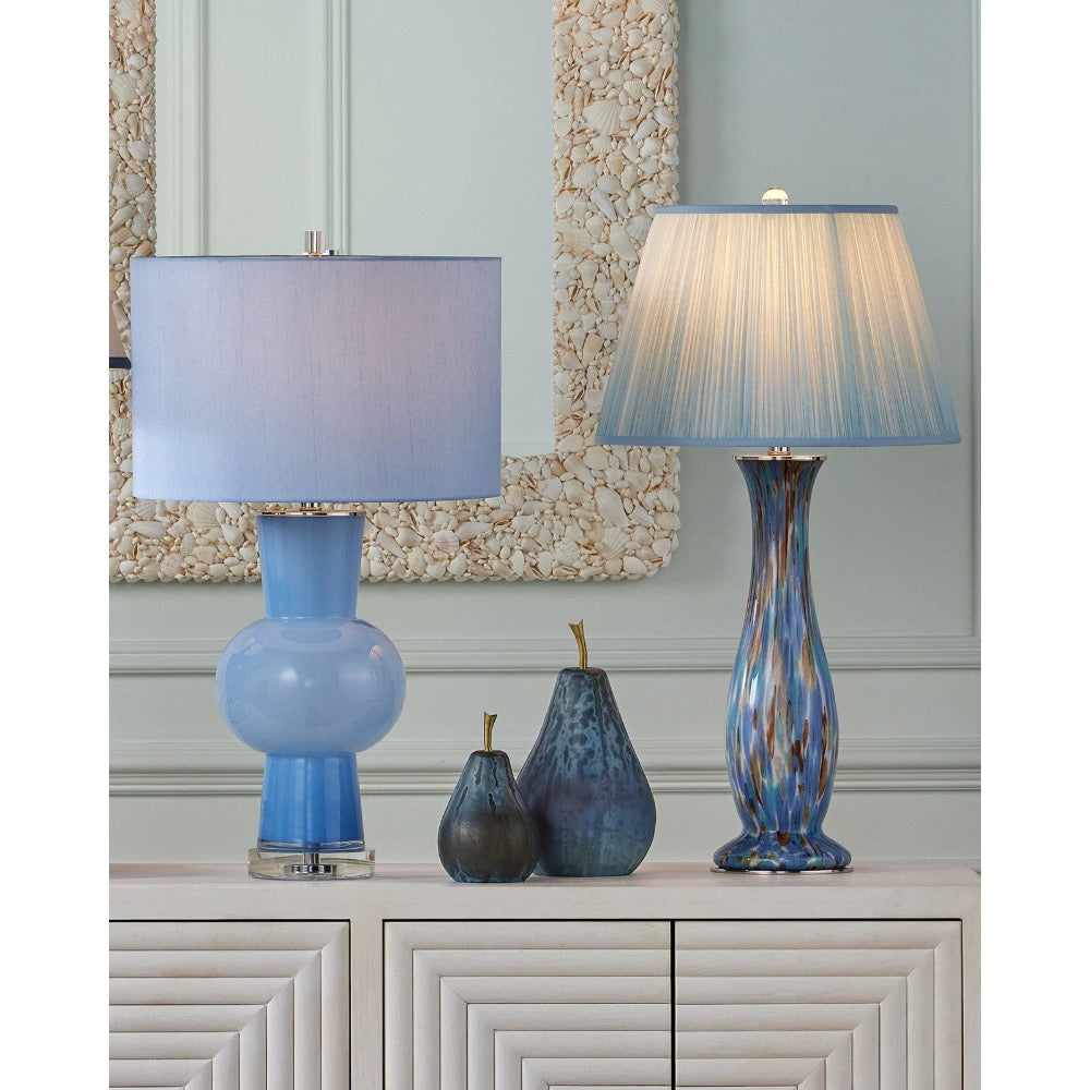 Two blue table lamps on a cabinet with decorative vases and a mirror in the background.