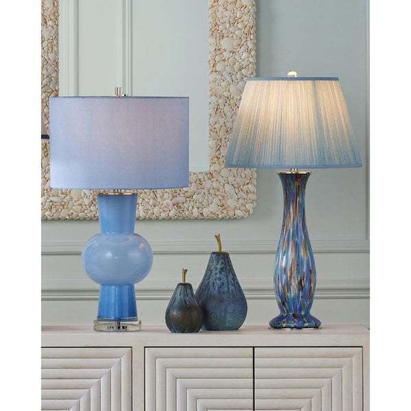 Two blue table lamps on a cabinet with decorative vases and a mirror in the background.