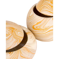 Two round lidded ceramic vases with a marbled swirl pattern in cream, beige, and orange, shown on a plain white background.
