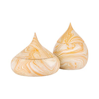 Two teardrop-shaped lidded containers with a cream and yellow marbled pattern, shown on a plain white background.
