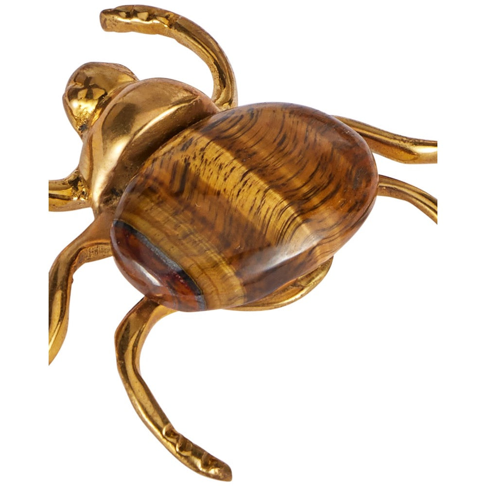 A decorative beetle figurine with a polished gold-finished metal body and a large oval abdomen featuring natural tiger's eye wood grain in brown and gold tones, shown on a plain white background.