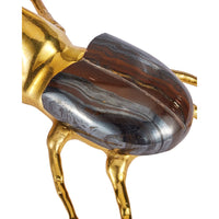 Close-up of a decorative animal sculpture with a polished metallic gold body and a large curved back panel featuring a marbled brown, black, gray, and silver pattern, shown on a plain white background.