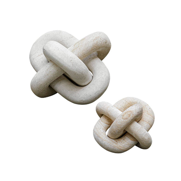 Two stone knot sculptures on a white background