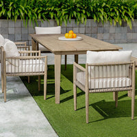 Outdoor furniture set with a wooden table and chairs on a grassy area.