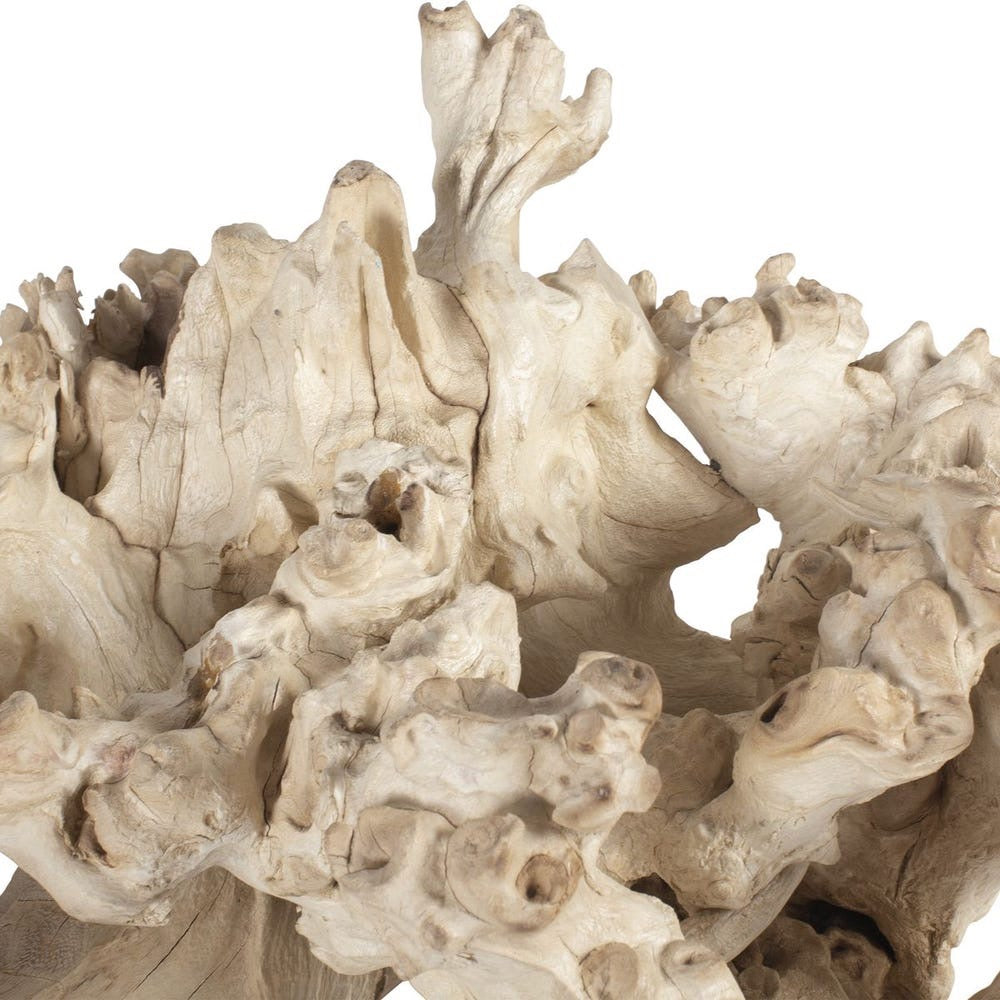 Close-up of a textured beige stone sculpture on a white background