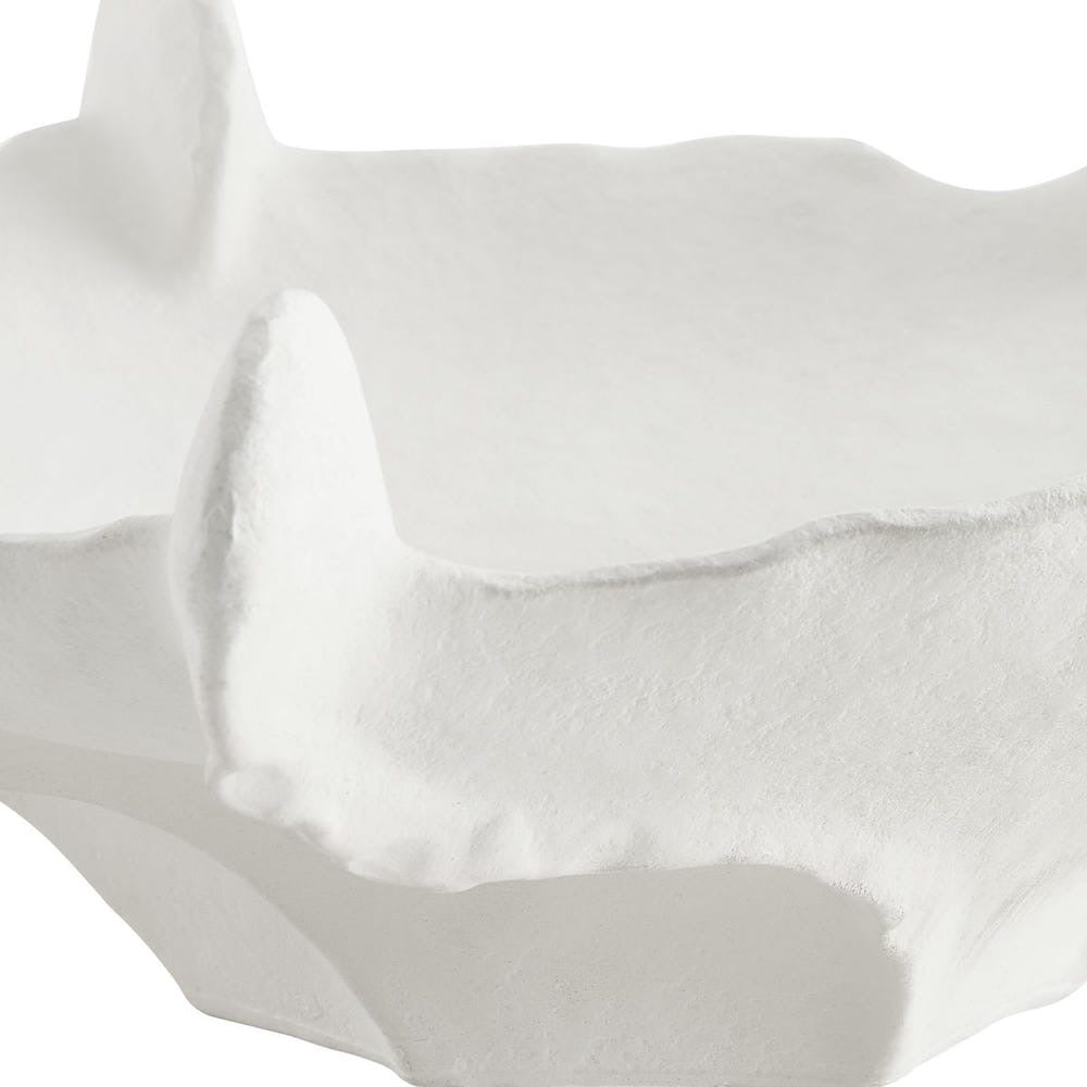 Close-up of white bowl with folds on a white background