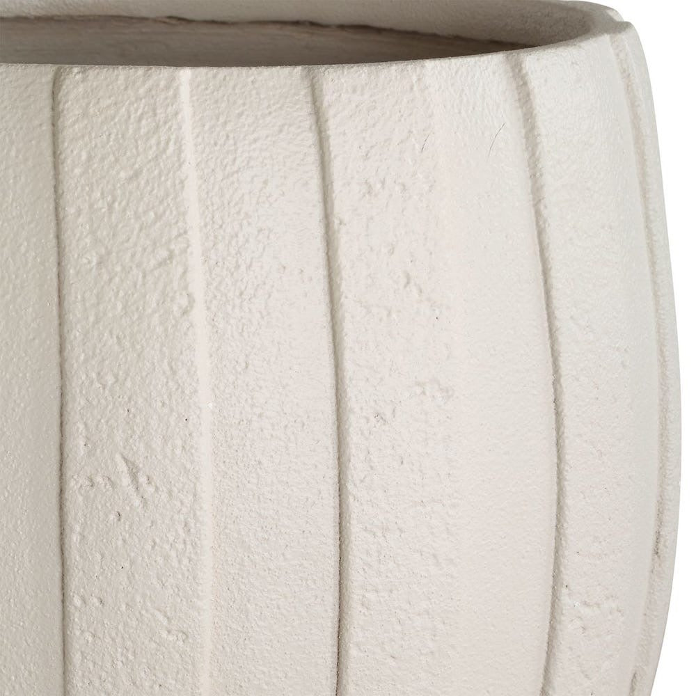 Close-up of a textured white planter with concentric striped patterns.