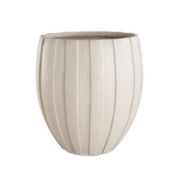 Beige ceramic planter with ribbed texture on a white background