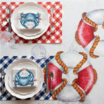 Hester & Cook's nautical-themed table setting showcases life rings and crab motifs on the Picnic Check Red + Blue Paper Placemats Pad, beautifully printed with soy-based ink, complemented by checkered plates and napkins.