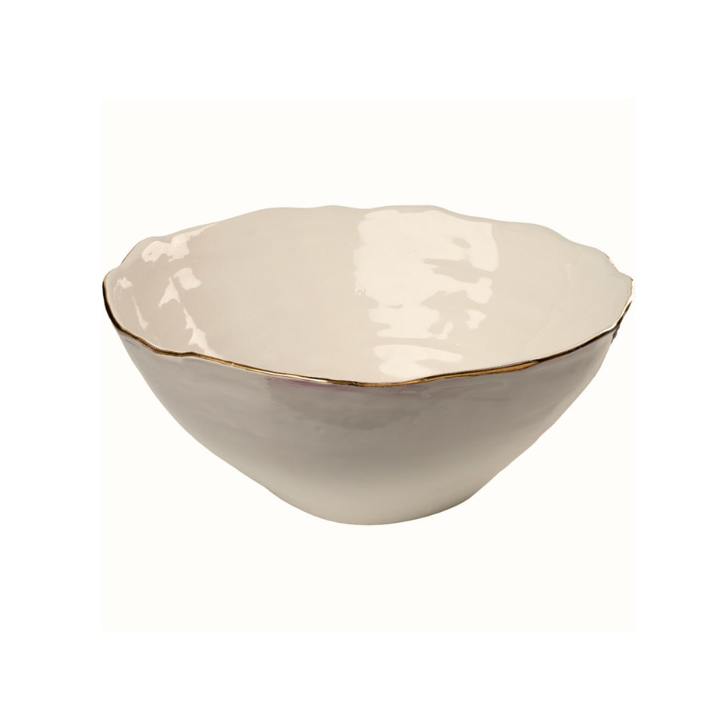 Beige ceramic bowl with gold rim on a white background