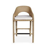 Wicker bar stool with a white cushion on a white background
