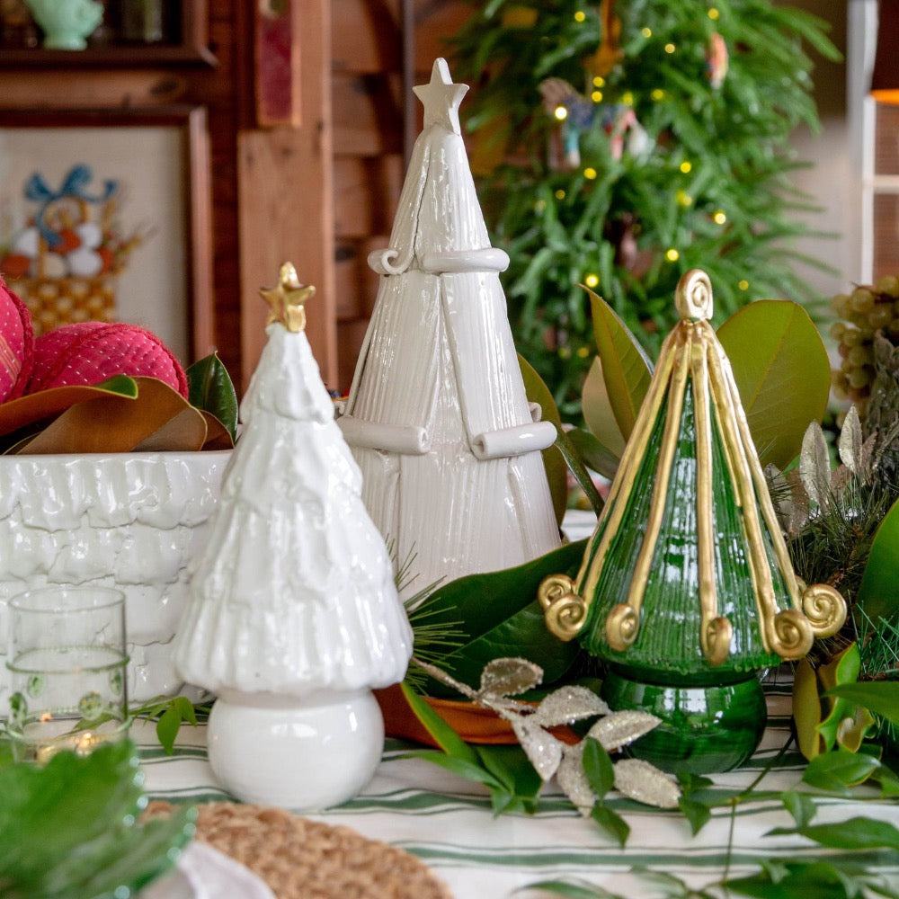 Decorative Christmas trees on a table with a festive background