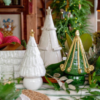 Decorative Christmas trees on a table with a festive background