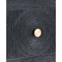 A close-up of a dark charcoal textured cabinet or door featuring a large circular concentric design with a central round gold knob.